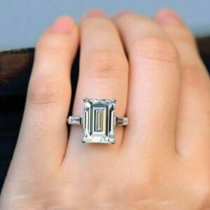 High impact silver jewelry showcasing a large emerald cut moissanite centerpiece A ring that blends editorial style with fine jewelry excellence Built for standout moments and iconic looks