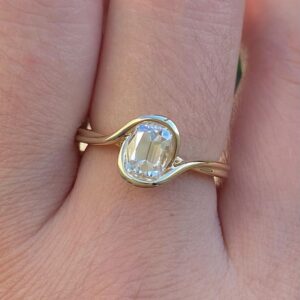 Bezel set moissanite in silver with a fluid, wave-like silhouette A design that feels organic, smooth, and naturally elegant Made for a modern heirloom with a soft, sculpted touch