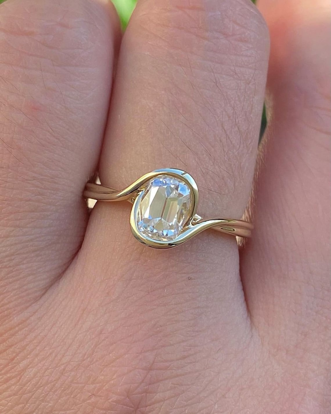 Bezel set moissanite in silver with a fluid, wave-like silhouette A design that feels organic, smooth, and naturally elegant Made for a modern heirloom with a soft, sculpted touch