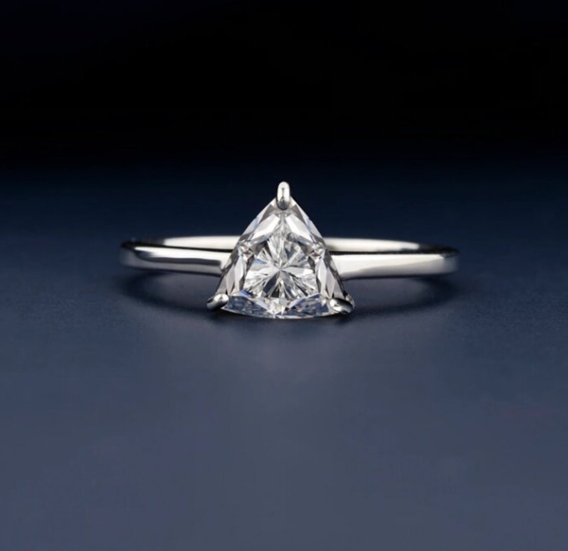 Fine silver setting featuring a triangular moissanite with crisp brilliance A piece that embodies precision luxe with a sleek, refined finish Designed for those who favor sharp lines and pure elegance