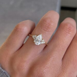 Delicate silver silhouette holding a pear moissanite with airy brilliance A design that feels light, graceful, and quietly luxurious Created for modern elegance with a soft statement feel