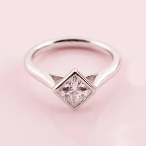 crisp silver band featuring a moissanite that catches every glance Where sharp design meets soft, radiant sparkle effortlessly Perfect for making a subtle yet unforgettable statement