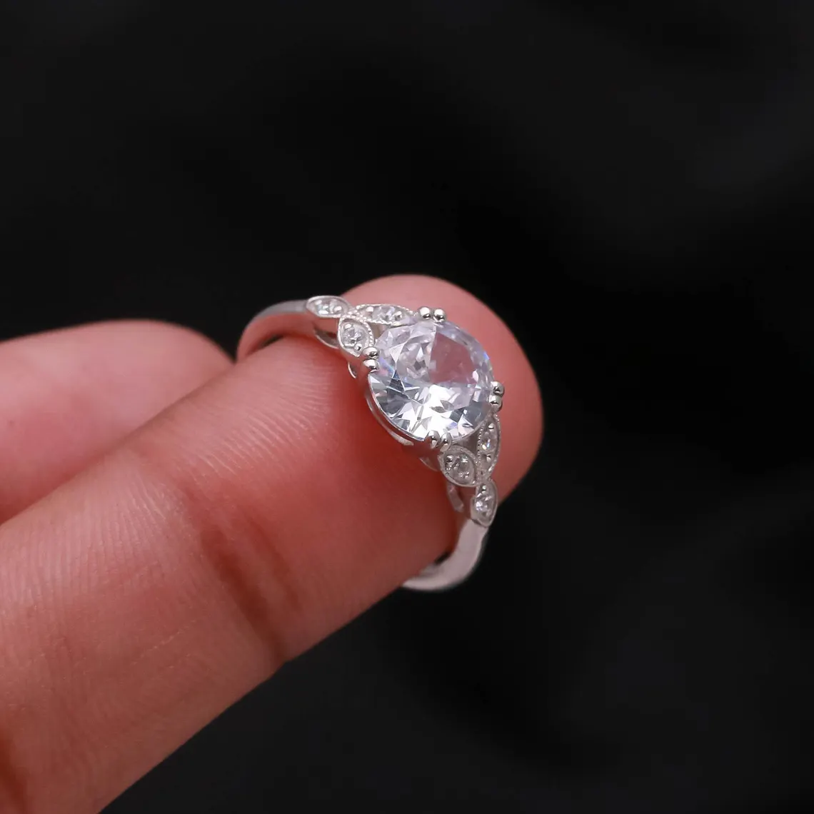 Vintage Style Oval Cut Moissanite Engagement Ring in Silver Elegant Milgrain Leaf Design with Side Accent Stones, Antique Inspired Floral Band, Delicate Yet Eye Catching Bridal Jewelry for Women - Image 5