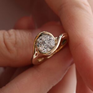 Modern Bezel Set Round Moissanite Ring in Gold Tone Silver Unique Wave Wrap Band Design with Sleek Contemporary Minimalist Elegance for Women