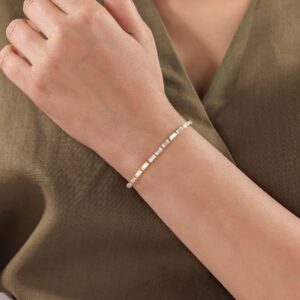 A modern expression of fine jewelry featuring emerald cut diamonds in 14K gold arranged in a seamless line that delivers subtle sparkle with a sophisticated edge