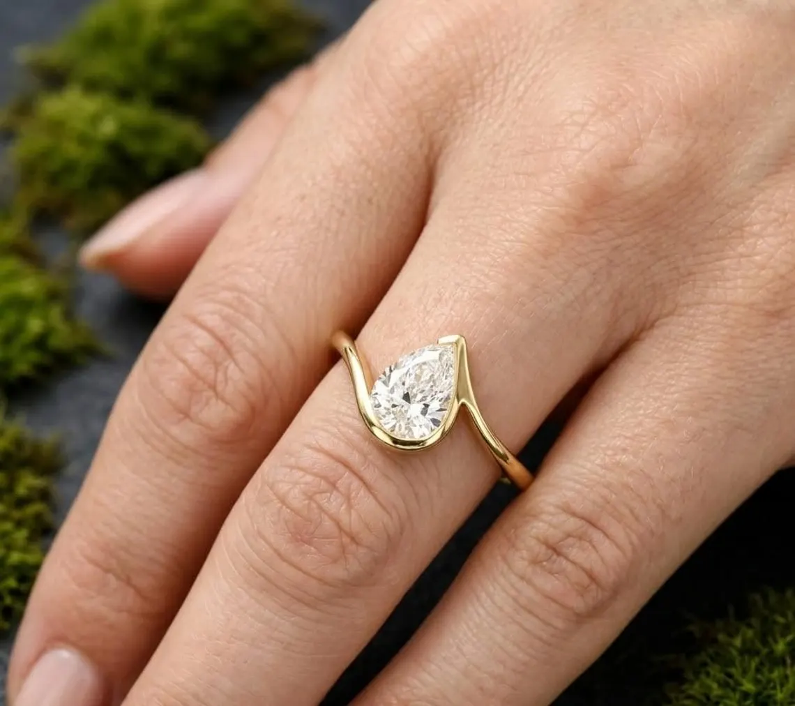A sculpted silver band holding a glowing moissanite centerpiece Where creativity meets refined sparkle in perfect balance Designed for elegance that feels different and unforgettable