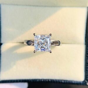 Princess Cut Moissanite Engagement Ring in Silver Elegant Four Prong Solitaire Design with Modern Minimalist Style, Dainty Yet Eye Catching Bridal Jewelry for Women