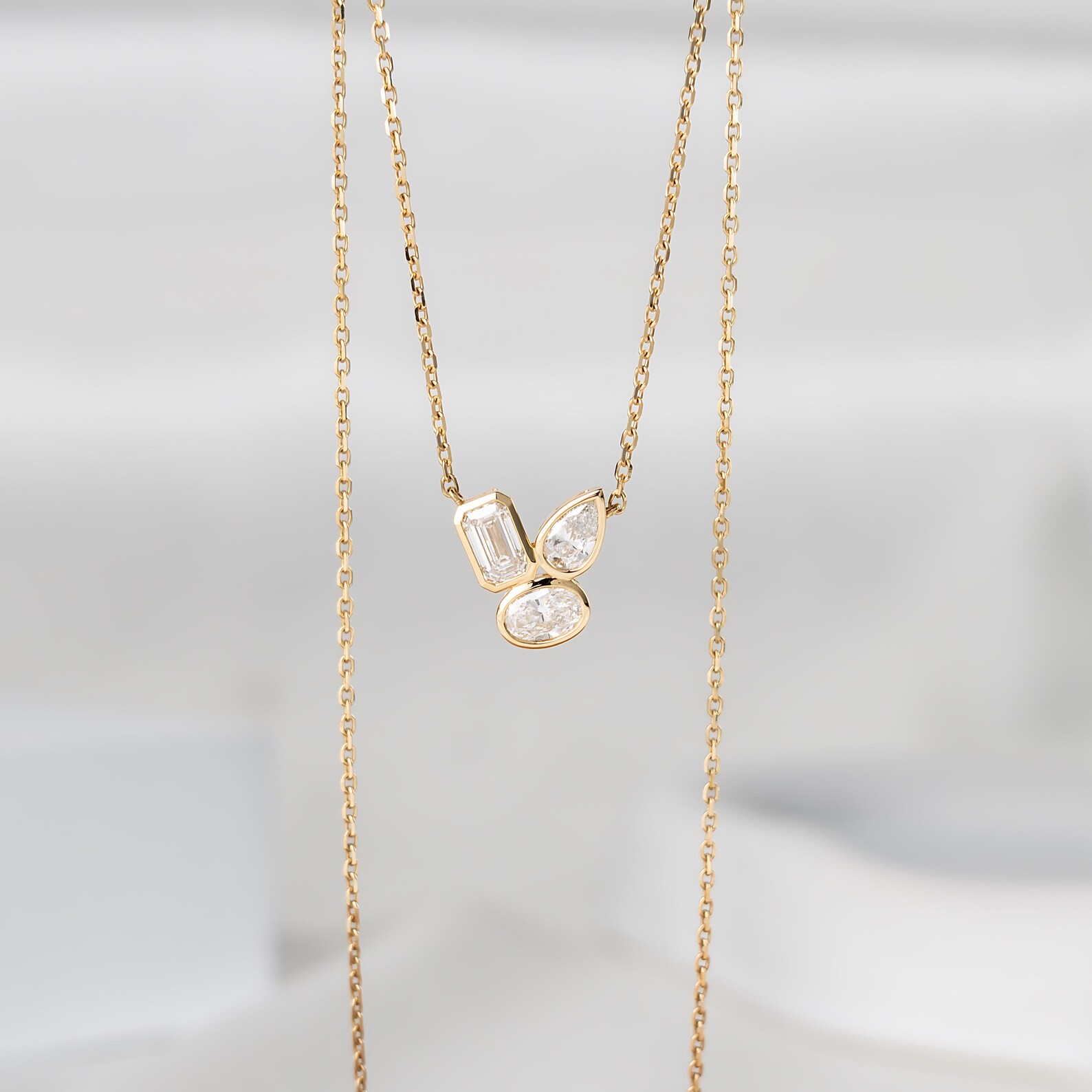 Unique Artistic Layout and Modern Multi Shape Diamond Pendant Necklace in 14K Gold Featuring Emerald Pear and Oval Stones Dainty Statement Jewelry Piece with Geometric Elegance Designed