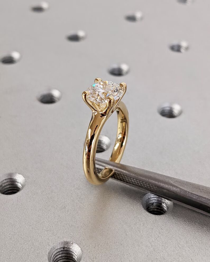 Delicate emerald-cut diamond engagement ring with side stones, set in 14K yellow gold, vintage-inspired minimalist design with elegant sparkle - Image 5