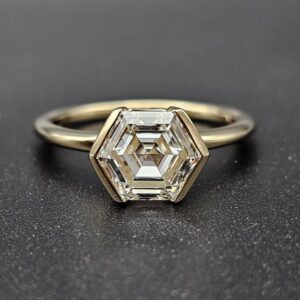 Hexagon cut diamond solitaire engagement ring in a sleek bezel setting, crafted in 14K yellow gold Luxury modern design with bold geometry, refined elegance, and high end sophisticated sparkle