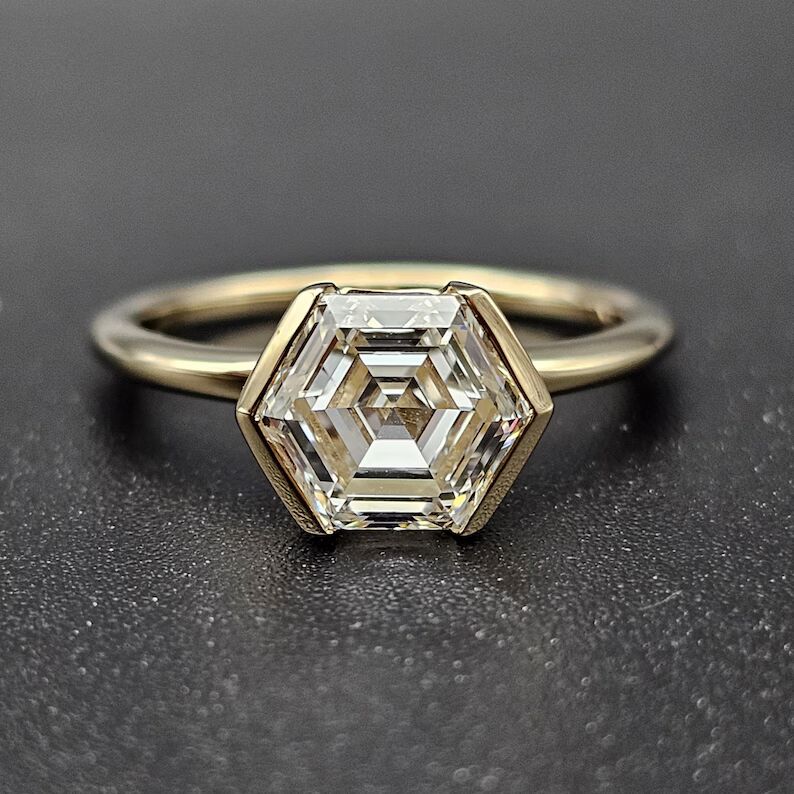 Hexagon cut diamond solitaire engagement ring in a sleek bezel setting, crafted in 14K yellow gold Luxury modern design with bold geometry, refined elegance, and high end sophisticated sparkle