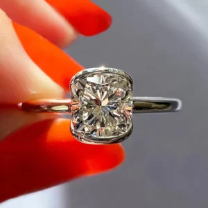 Infinity Spark cushion cut diamond solitaire engagement ring in a sleek bezel setting, crafted in 14K white gold, featuring a modern minimalist design with bold brilliance and refined sparkle