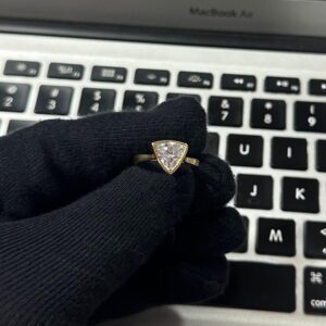 Trillion cut diamond solitaire engagement ring in a sleek bezel setting, crafted in 14K yellow gold Classic yet modern design with clean geometric lines, refined sparkle, and a bold sophisticated look