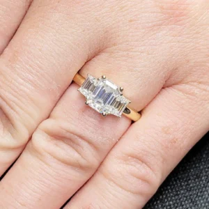 Nova Shine Emerald Cut Diamond Engagement Ring with Tapered Baguette Side Stones Set in a Classic Prong Setting on a Sleek Polished 14K Yellow Gold Band