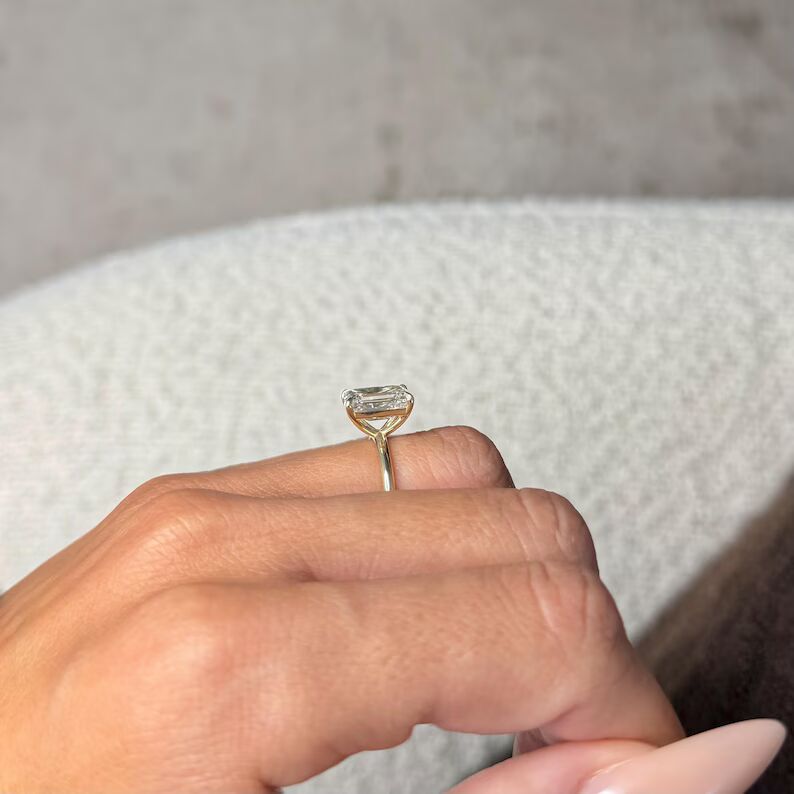 Infinite Charm solitaire engagement ring featuring a stunning elongated emerald-cut diamond with crisp clean step facets, set in a sleek polished 14K yellow gold band, showcasing timeless sophistication, modern luxury, and refined brilliance with a bold yet graceful presence - Image 4