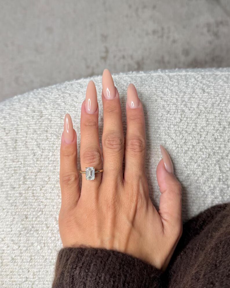 Infinite Charm solitaire engagement ring featuring a stunning elongated emerald-cut diamond with crisp clean step facets, set in a sleek polished 14K yellow gold band, showcasing timeless sophistication, modern luxury, and refined brilliance with a bold yet graceful presence - Image 3