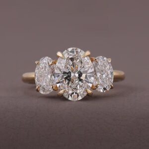 Three stone oval cut diamond engagement ring, crafted in 14K yellow gold Classic timeless design with matching oval side stones, balanced proportions, and brilliant luxurious sparkle